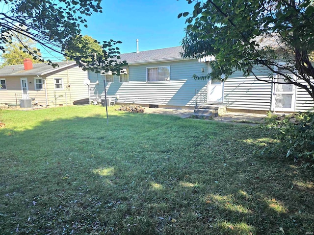 exterior space with a yard and central AC unit