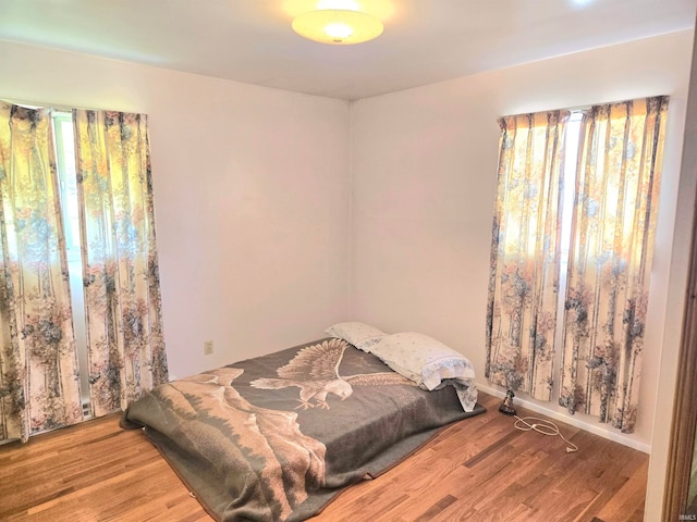 bedroom with hardwood / wood-style flooring