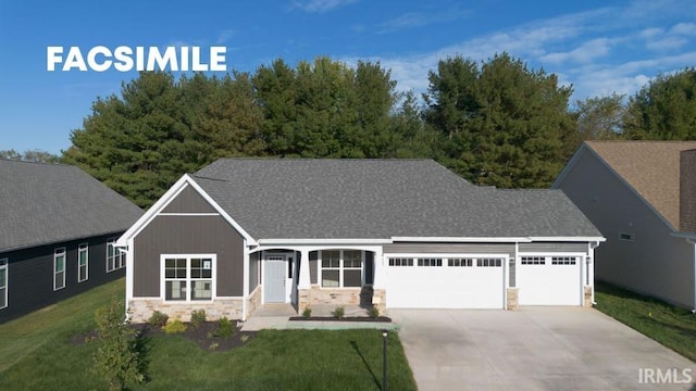 view of front of property featuring a front yard and a garage