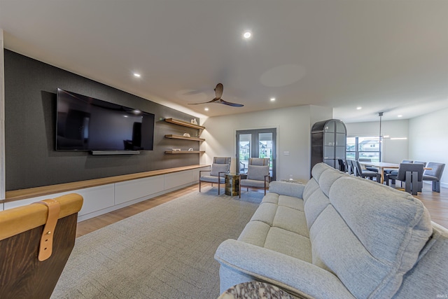 living room featuring light hardwood / wood-style floors and ceiling fan