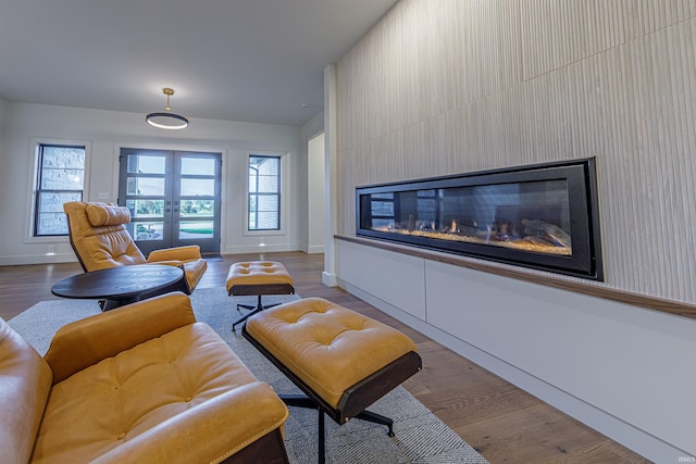 living room featuring light wood-type flooring and a fireplace