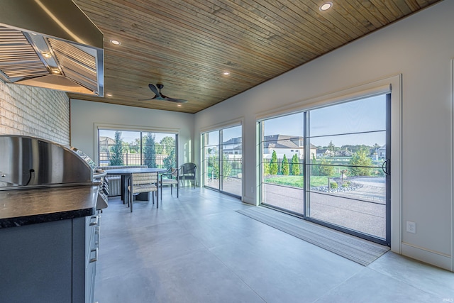 unfurnished sunroom with lofted ceiling, ceiling fan, and wooden ceiling