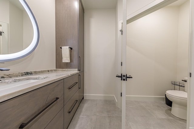 bathroom with tile patterned floors, vanity, and toilet