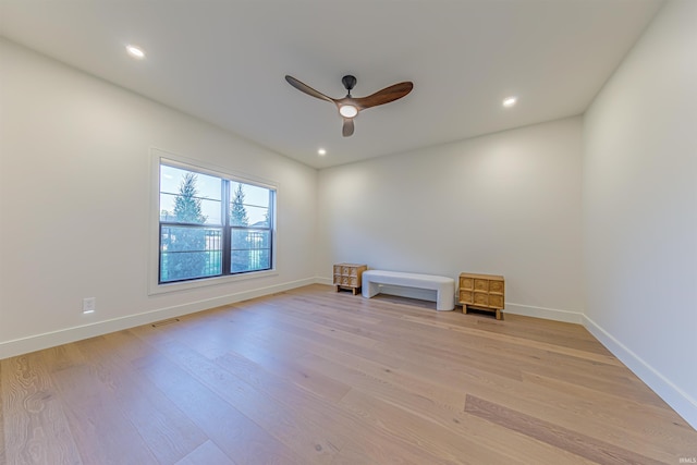 spare room featuring light hardwood / wood-style floors and ceiling fan