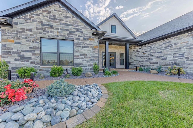 view of exterior entry featuring a yard