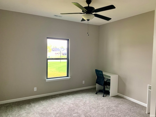 unfurnished office featuring carpet flooring and ceiling fan