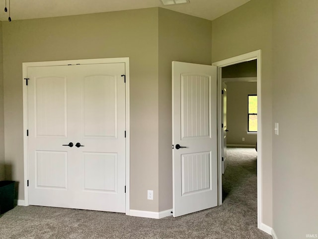 unfurnished bedroom with a closet and carpet floors