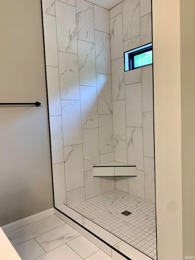 bathroom featuring a tile shower