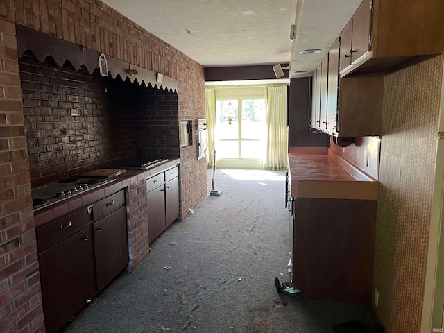 kitchen featuring light colored carpet and a textured ceiling