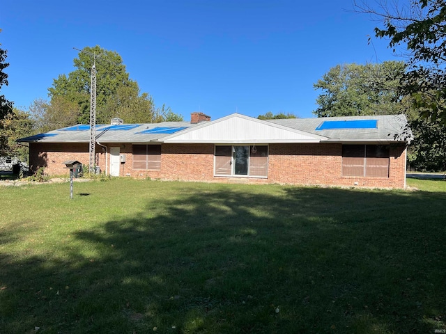 rear view of house featuring a yard