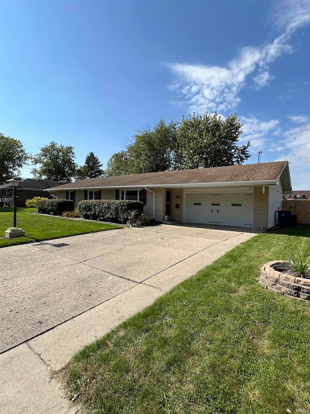 single story home with a garage and a front lawn