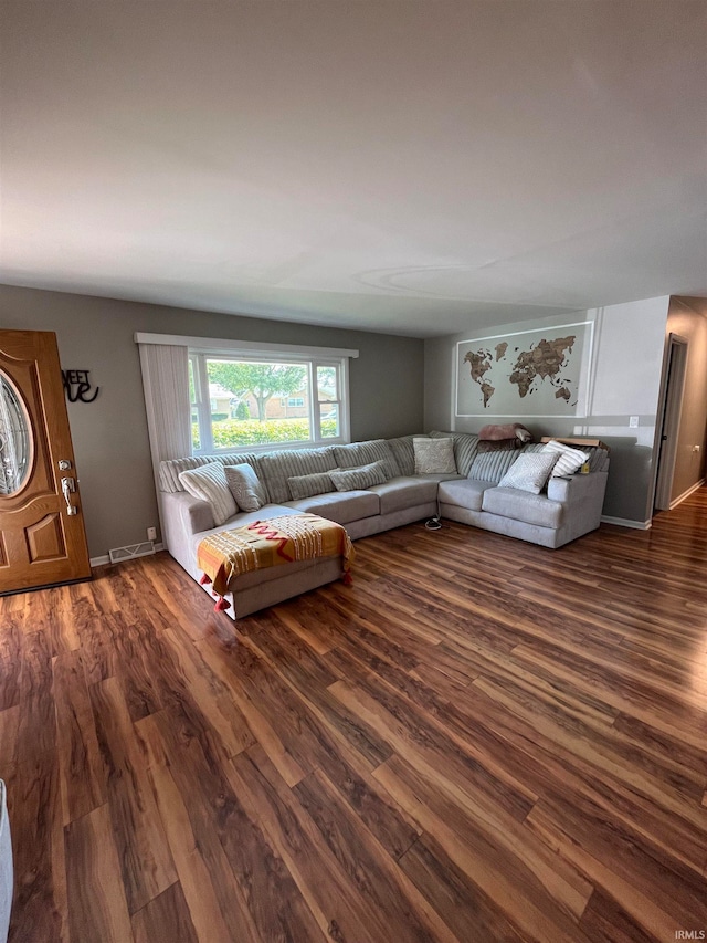 unfurnished living room featuring dark hardwood / wood-style floors