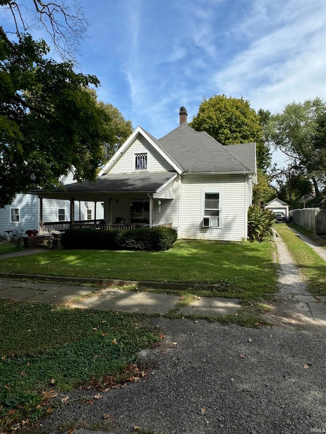 view of front of property featuring a front yard and cooling unit