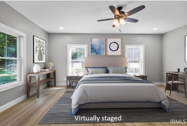 bedroom featuring hardwood / wood-style flooring and ceiling fan