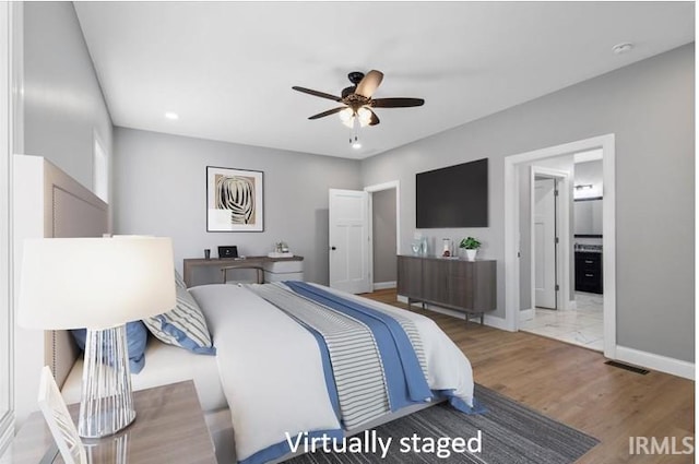 bedroom with ceiling fan and hardwood / wood-style floors