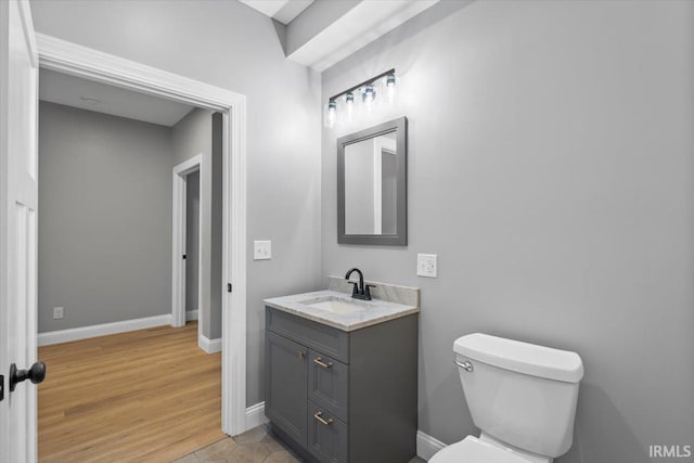 bathroom featuring vanity, hardwood / wood-style floors, and toilet