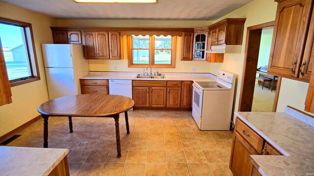 kitchen featuring white appliances and sink