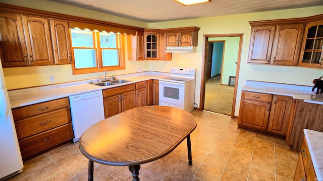 kitchen featuring white appliances and sink