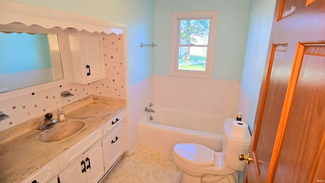 bathroom featuring vanity, a bathing tub, backsplash, and toilet