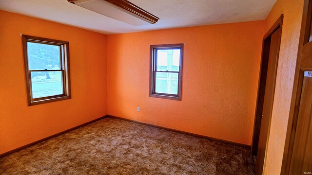 bedroom featuring light colored carpet, baseboard heating, and vaulted ceiling