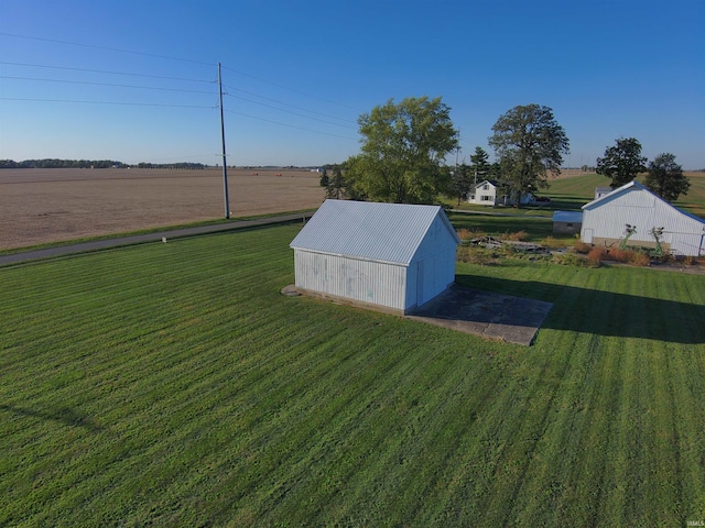 view of yard featuring an outbuilding and a rural view