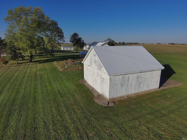 view of outbuilding featuring a lawn