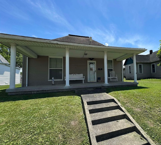 view of front of home with a front yard and covered porch