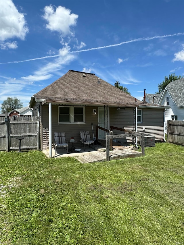 rear view of house featuring outdoor lounge area, central air condition unit, a lawn, and a patio area