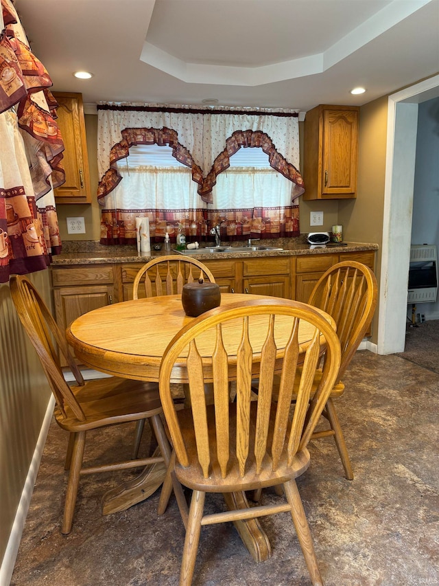 dining area with heating unit, wet bar, and a raised ceiling