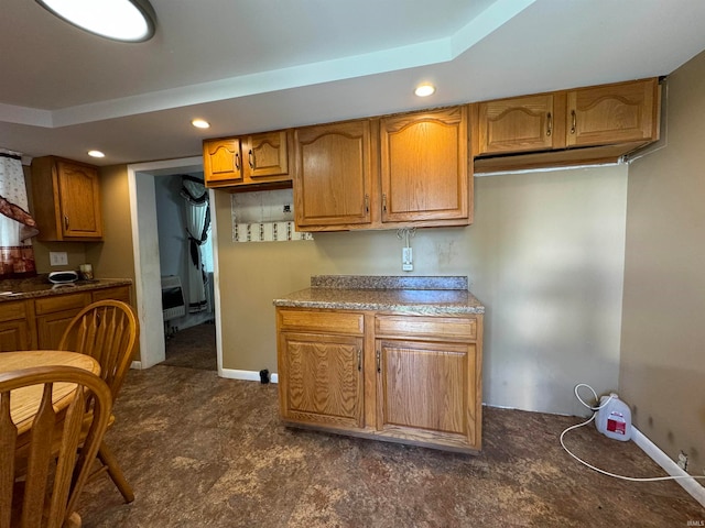 kitchen with a raised ceiling and heating unit