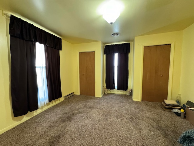 unfurnished bedroom featuring carpet and a baseboard radiator