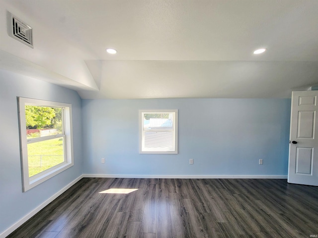 unfurnished room with vaulted ceiling and dark hardwood / wood-style floors