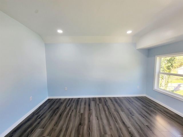 empty room with dark wood-type flooring