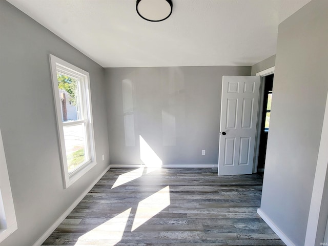 empty room with dark hardwood / wood-style flooring