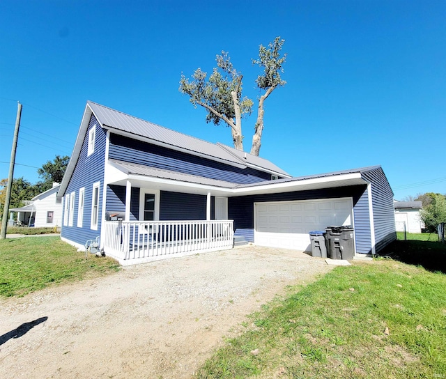 view of front of house featuring a front yard, a garage, solar panels, and covered porch