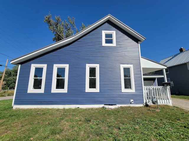 view of property exterior with a lawn