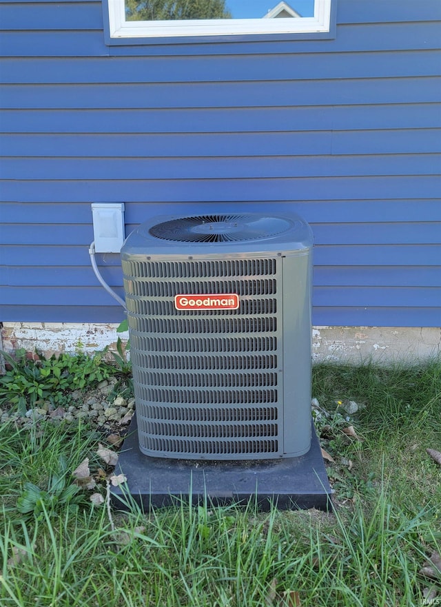 details featuring wooden walls and central air condition unit