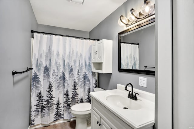 bathroom featuring a shower with curtain, hardwood / wood-style flooring, vanity, and toilet