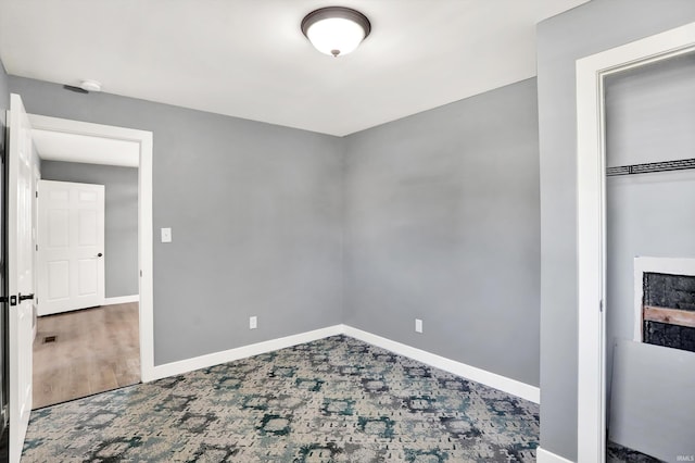 unfurnished bedroom featuring a closet and hardwood / wood-style flooring