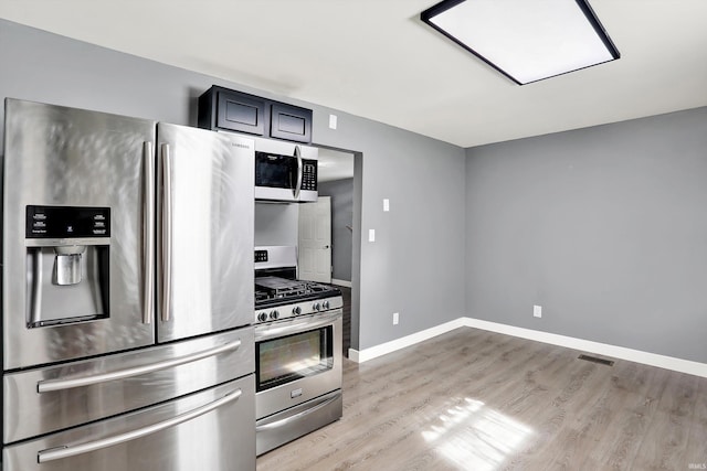 kitchen featuring stainless steel appliances and light hardwood / wood-style floors