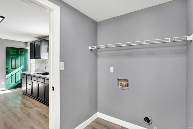 laundry room with washer hookup, light hardwood / wood-style floors, and electric dryer hookup