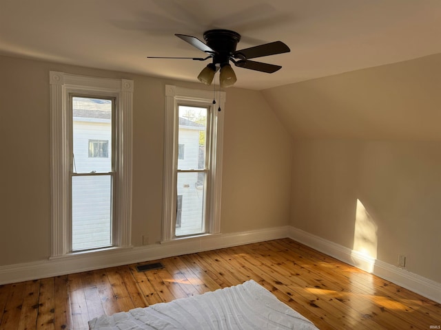 additional living space with ceiling fan, light wood-type flooring, and lofted ceiling