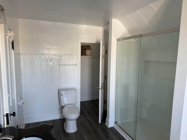 bathroom with hardwood / wood-style floors, vanity, walk in shower, and toilet