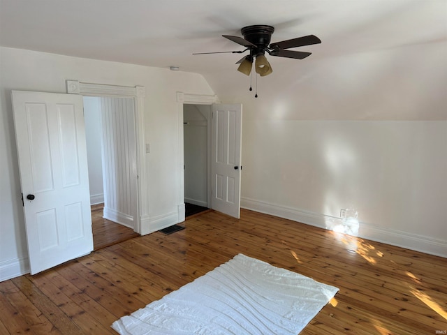 bedroom with ceiling fan, vaulted ceiling, and dark hardwood / wood-style flooring