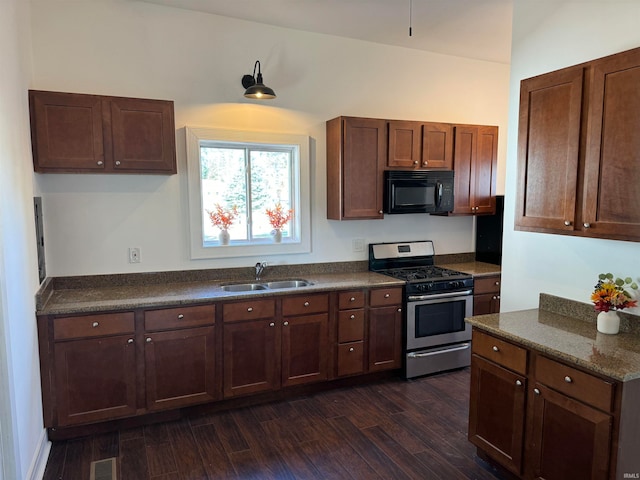 kitchen with stainless steel range with gas stovetop, sink, and dark hardwood / wood-style floors