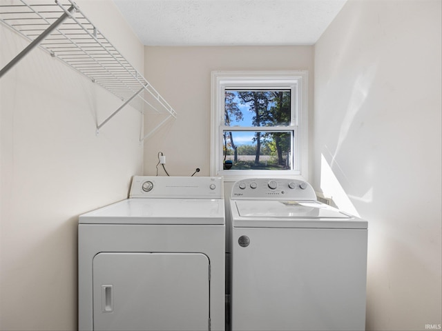 washroom featuring washer and dryer and a textured ceiling