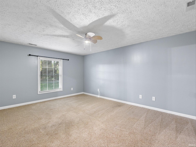 spare room with ceiling fan, a textured ceiling, and carpet flooring