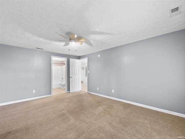 unfurnished room featuring light carpet, ceiling fan, and a textured ceiling