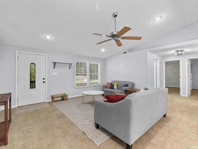 carpeted living room with lofted ceiling, ceiling fan, and a textured ceiling