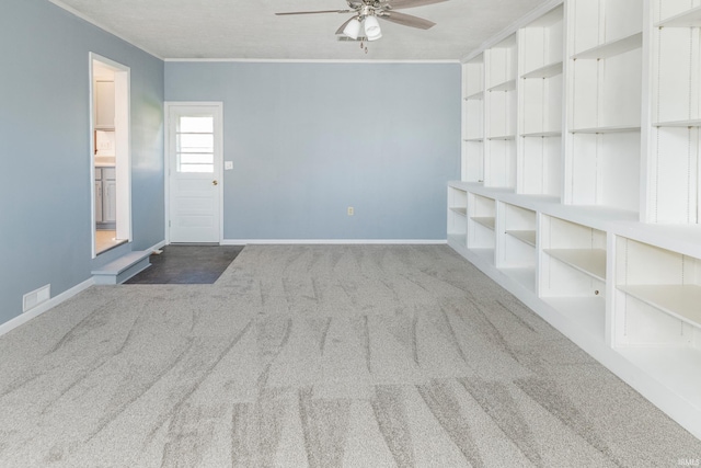 carpeted empty room with ornamental molding, a textured ceiling, and ceiling fan